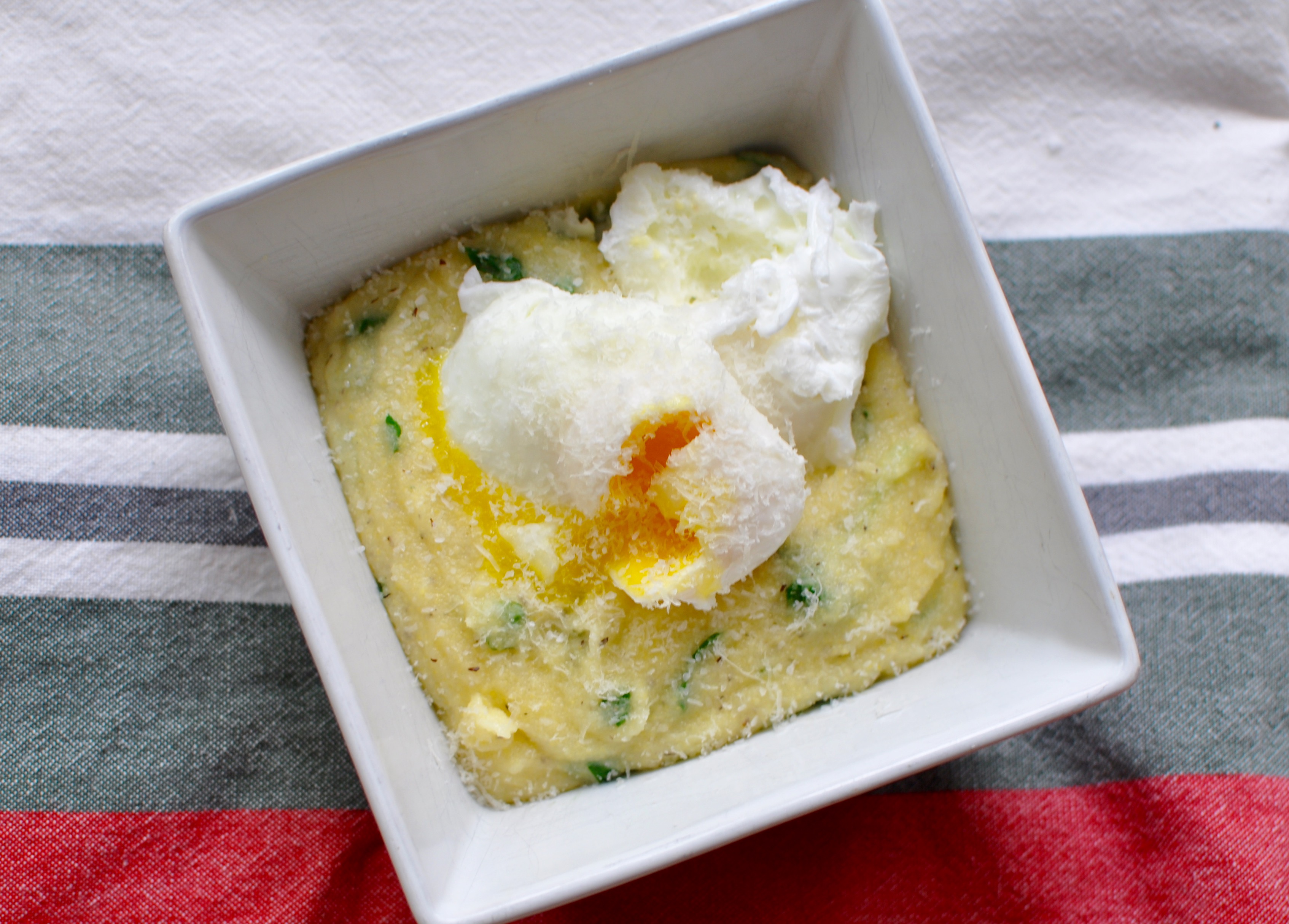 picture of a hot bowl full of polenta and 2 poached eggs