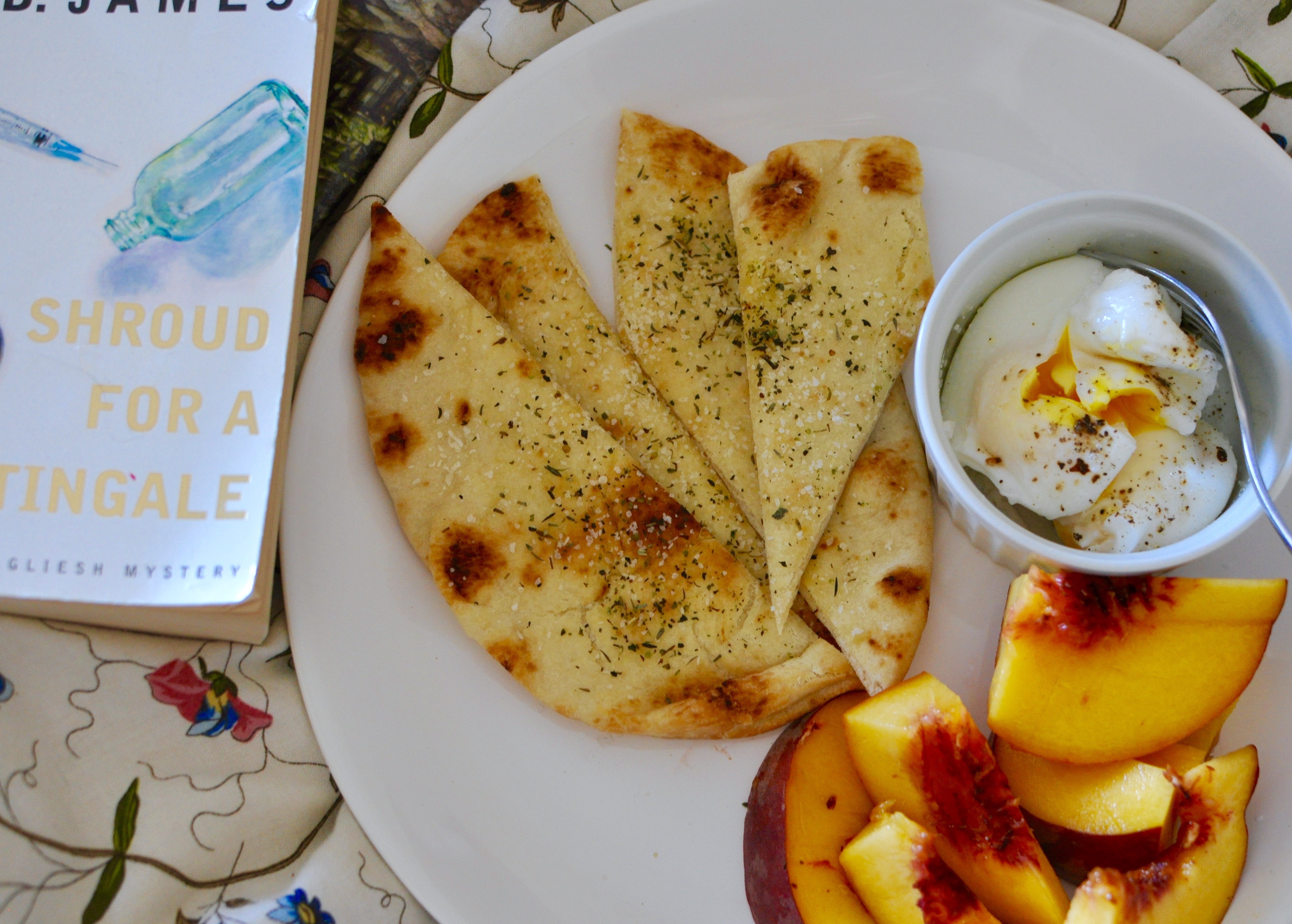 Breakfast in Bed with peaches, flatbread, and poached eggs.