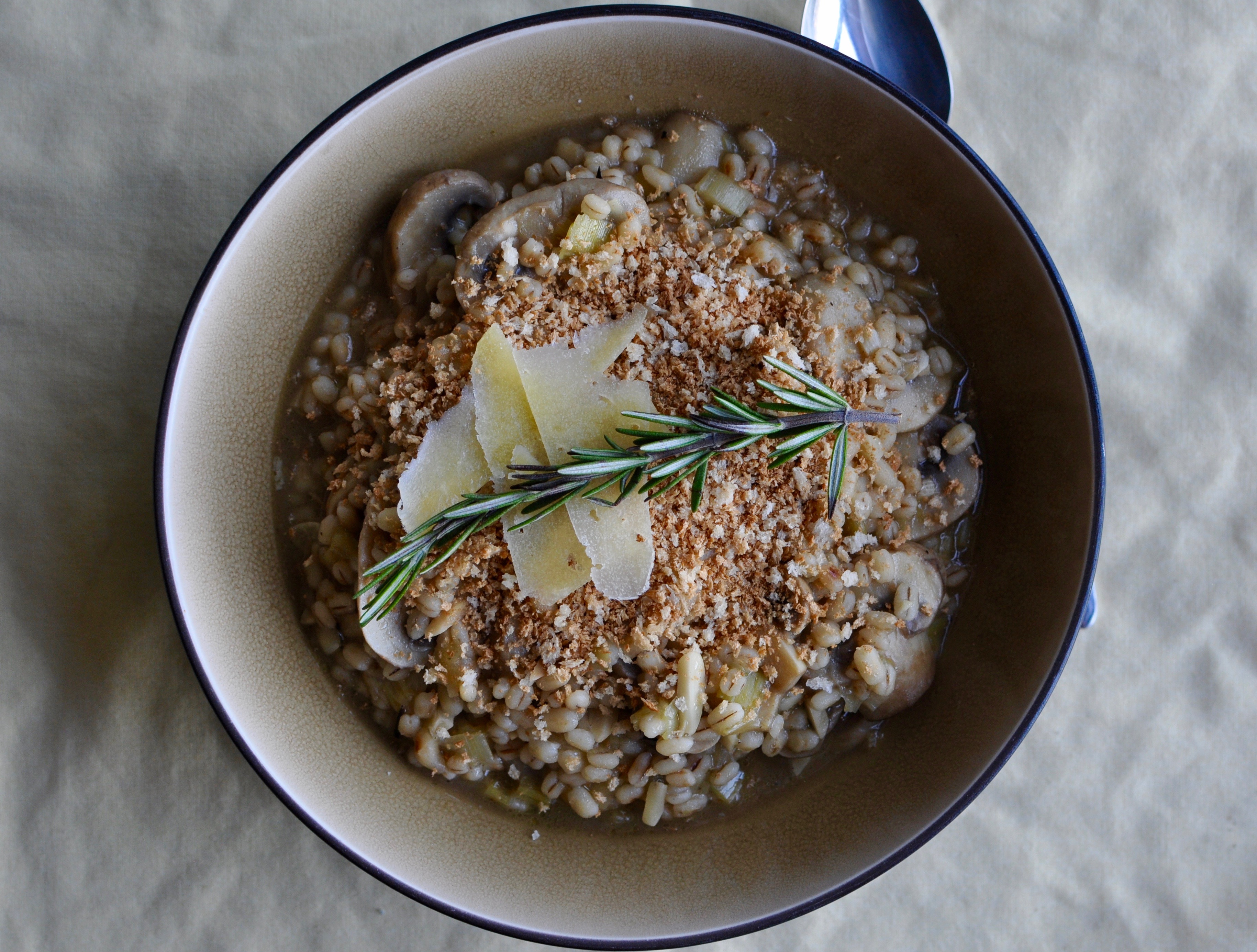 Bowl of barley risotto with rosemary and Mahon cheese