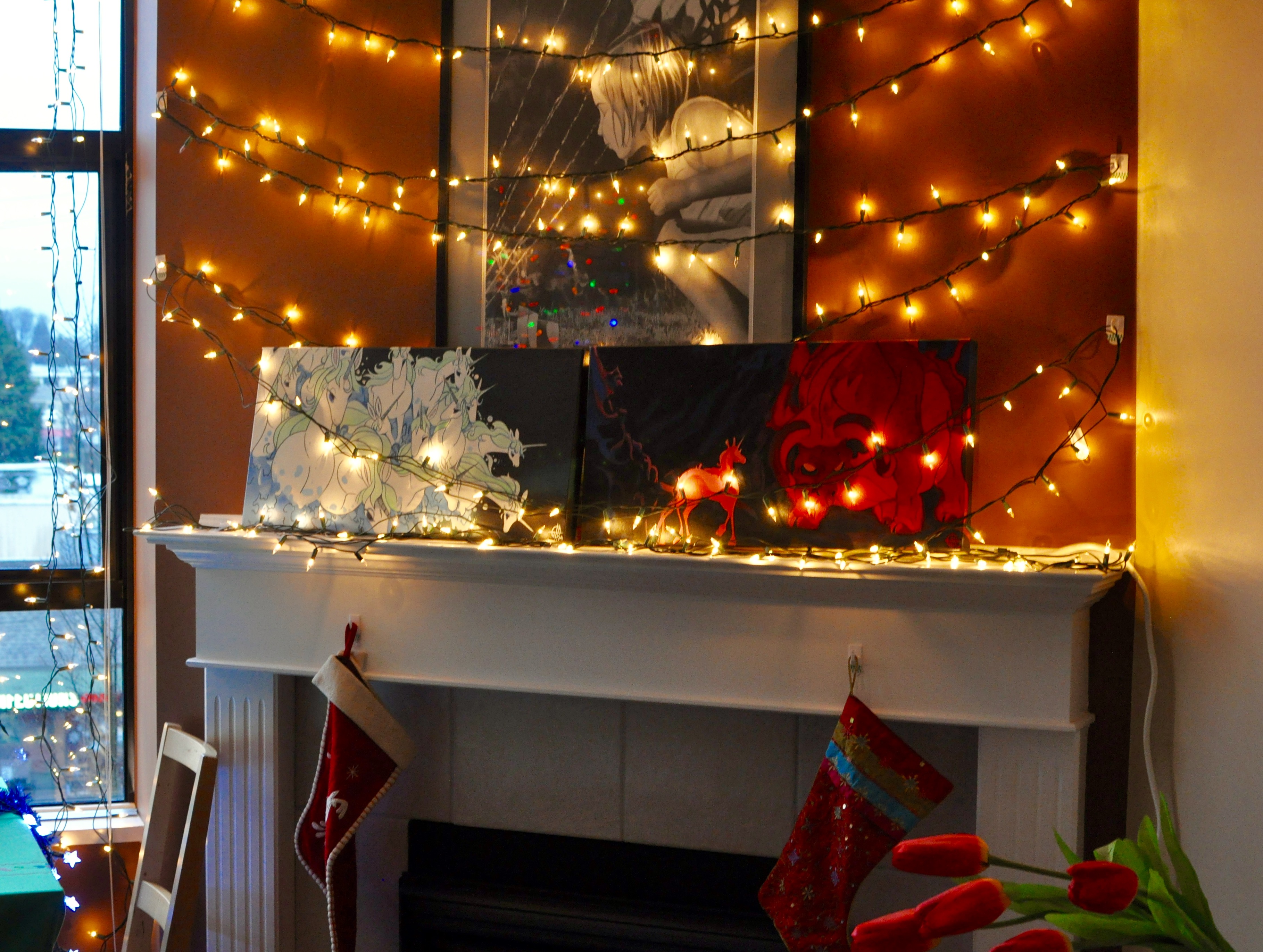 Christmas mantelpiece with lights crisscrossed across the wall.