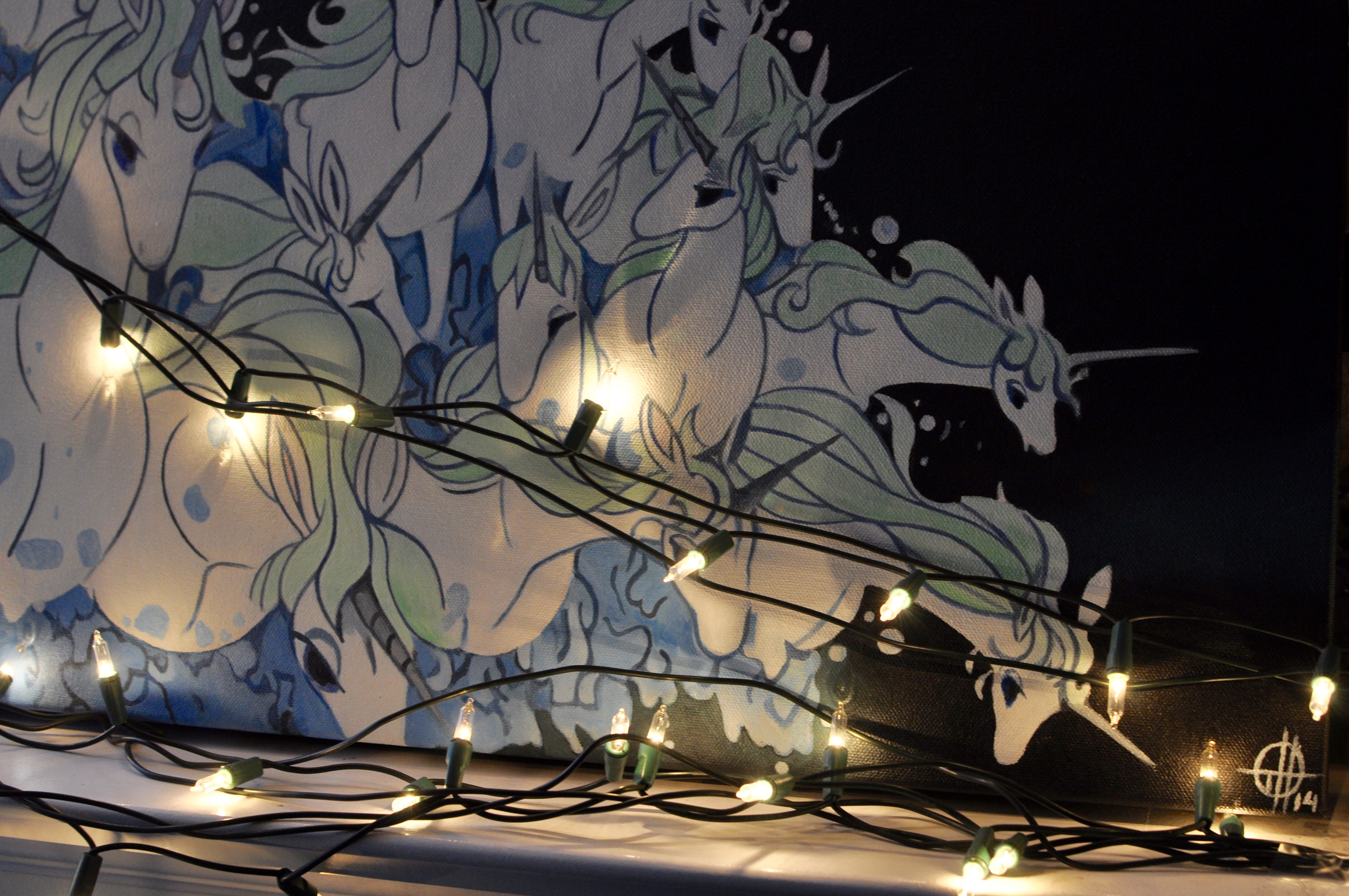 Close up of Christmas lights and the Last Unicorn Painting.