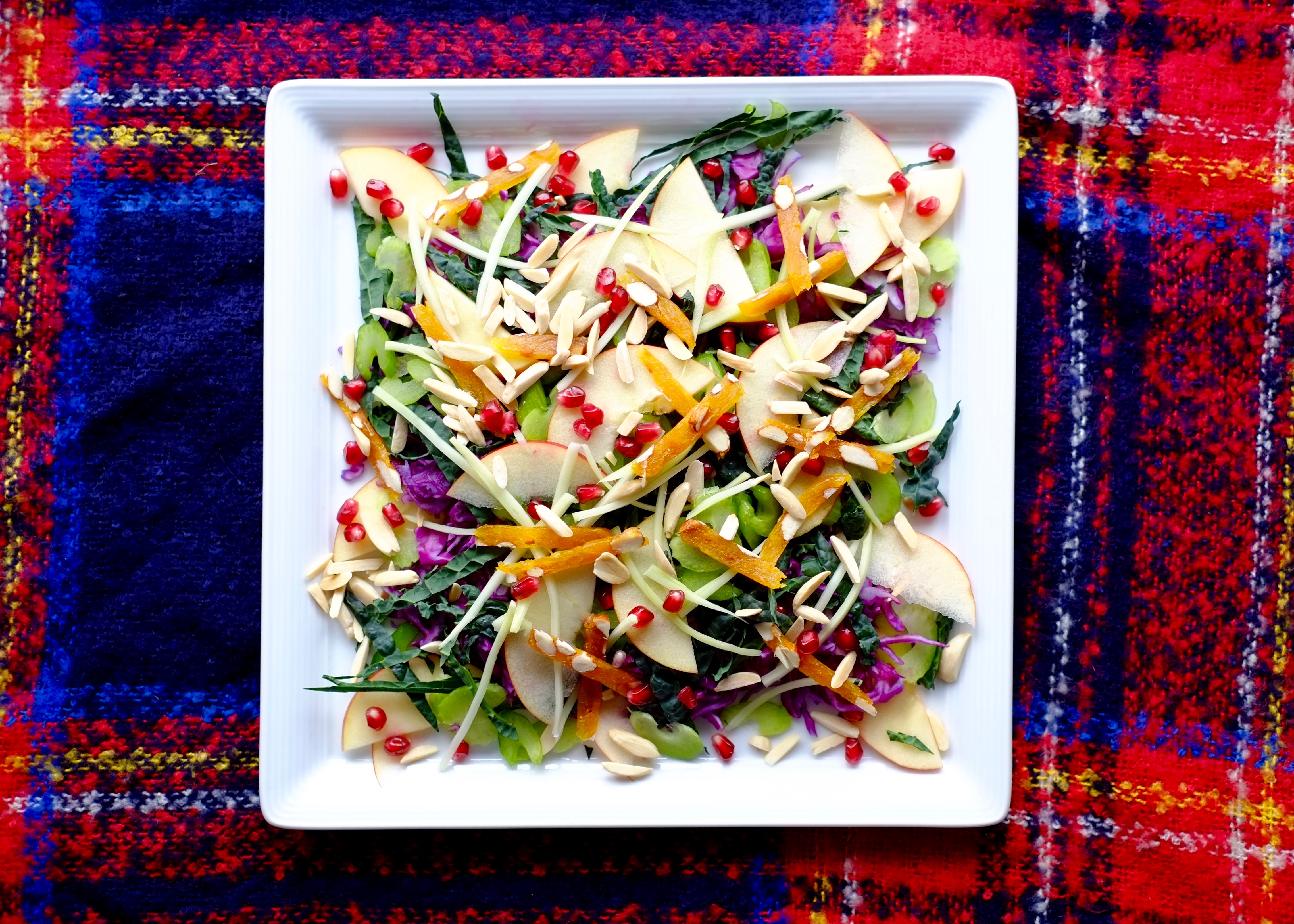 Big crunchy winter salad on a white plate.